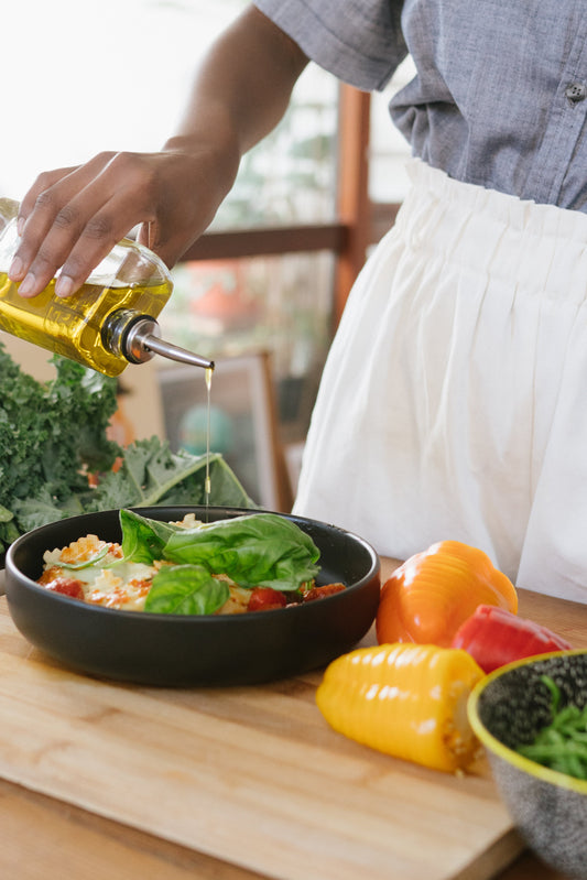 Cold Pressed OIl being poured onto a salad
